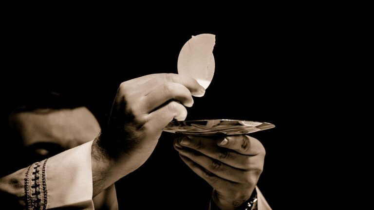 Priest gives communion