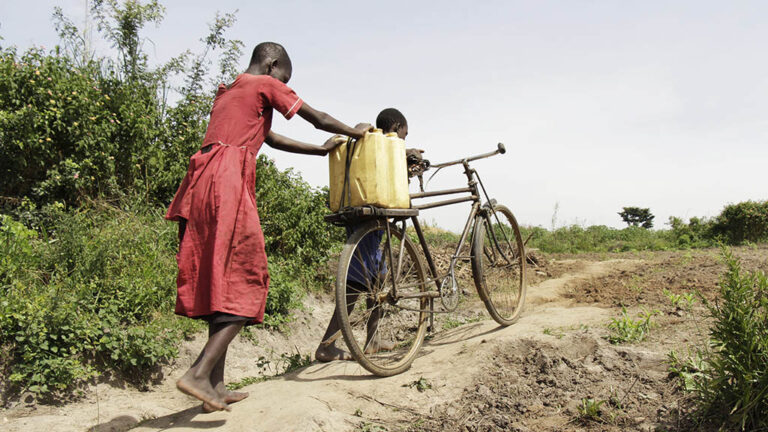 Children in Uganda carry water by bicycle
